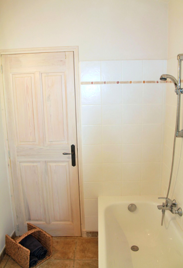 Bathtub and shower in the bathroom close to the master bed room